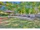 Spacious backyard with a gazebo, storage shed, basketball court, and well-maintained lawn at 225 N Phippen Ave, Deland, FL 32724