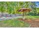 Lush backyard with mature trees, a gazebo, ample grass, and plenty of room for outdoor activities at 225 N Phippen Ave, Deland, FL 32724