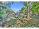Green backyard features fire pit, playground, shed, gazebo, and home at 225 N Phippen Ave, Deland, FL 32724