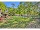 Large green backyard complete with playground, shed, firepit, and gazebo at 225 N Phippen Ave, Deland, FL 32724