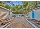 Large backyard featuring an outdoor kitchen with a fireplace and raised garden beds at 225 N Phippen Ave, Deland, FL 32724
