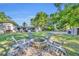 Inviting backyard with a stone fire pit circled by chairs, perfect for gatherings and relaxation at 225 N Phippen Ave, Deland, FL 32724