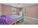 Bedroom with ceiling fan, two large windows and closet in a home at 225 N Phippen Ave, Deland, FL 32724