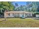 Charming single story home with blue door and manicured front lawn at 225 N Phippen Ave, Deland, FL 32724
