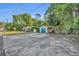 Exterior view of home with detached garage and long driveway at 225 N Phippen Ave, Deland, FL 32724
