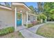 Welcoming front entrance with a blue door, charming sidelights, and a neatly landscaped walkway at 225 N Phippen Ave, Deland, FL 32724