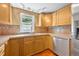 Updated kitchen with stainless steel dishwasher and sink, and earth-toned backsplash at 225 N Phippen Ave, Deland, FL 32724