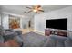 Open-concept living area with gray sectional and tile flooring flowing into the adjacent dining area at 225 N Phippen Ave, Deland, FL 32724