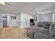 Spacious living area featuring tile flooring, a cozy gray sofa, and ample natural light at 225 N Phippen Ave, Deland, FL 32724