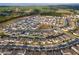 An aerial view of a suburban neighborhood with houses, landscape elements, and roads at 2290 Sw Raven Ridge Rd, Clermont, FL 34715