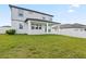 Two-story home with a covered patio, lush green grass and a white vinyl fence at 2290 Sw Raven Ridge Rd, Clermont, FL 34715