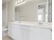 Bathroom featuring double sink vanity, and a large mirror reflecting a shower and door at 2290 Sw Raven Ridge Rd, Clermont, FL 34715
