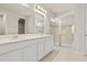 Bathroom featuring a double vanity sink, a glass door shower, and neutral colored walls at 2290 Sw Raven Ridge Rd, Clermont, FL 34715