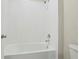 Bathroom featuring a white tiled shower and a tub combination with chrome fixtures at 2290 Sw Raven Ridge Rd, Clermont, FL 34715