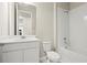 Stylish bathroom featuring a modern vanity, toilet, and tiled shower-tub combination at 2290 Sw Raven Ridge Rd, Clermont, FL 34715
