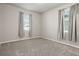 Cozy bedroom with neutral carpet, gray walls, and two windows with light-filtering curtains at 2290 Sw Raven Ridge Rd, Clermont, FL 34715