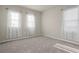 Bedroom featuring three windows with lace curtains and neutral carpet at 2290 Sw Raven Ridge Rd, Clermont, FL 34715