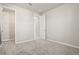 Bright bedroom boasts neutral walls, carpeted floor, and an open closet at 2290 Sw Raven Ridge Rd, Clermont, FL 34715