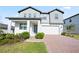 Lovely two-story home with a brick driveway, attached two car garage, and a welcoming front porch at 2290 Sw Raven Ridge Rd, Clermont, FL 34715