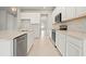 Well-appointed kitchen with white cabinetry, stainless steel appliances, and a light tile backsplash at 2290 Sw Raven Ridge Rd, Clermont, FL 34715