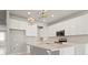 Beautiful kitchen showcasing white cabinets, a center island, stainless appliances, and stylish pendant lighting at 2290 Sw Raven Ridge Rd, Clermont, FL 34715