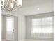 Contemporary living space with a chandelier, bright natural light from the window, and neutral wall color at 2290 Sw Raven Ridge Rd, Clermont, FL 34715