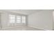 Spacious and bright living room with light-colored walls, tile floors, and ample natural light from the window at 2290 Sw Raven Ridge Rd, Clermont, FL 34715