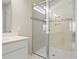 Updated shower with decorative tile, glass door, and convenient storage niche at 2290 Sw Raven Ridge Rd, Clermont, FL 34715