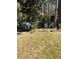 Backyard features a grill, lawn furniture, and mature trees providing shade and privacy at 2301 Avellino Ave, St Cloud, FL 34771