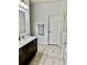 Clean bathroom with a vanity with ample storage, a framed mirror, and a glass shower at 2301 Avellino Ave, St Cloud, FL 34771