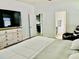 Comfortable bedroom with a dresser, TV, king bed, and ensuite bathroom providing a private retreat at 2301 Avellino Ave, St Cloud, FL 34771