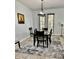 Dining area shows elegant table set, modern chandelier, and bright natural light coming through the back doors at 2301 Avellino Ave, St Cloud, FL 34771