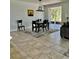 Bright dining area featuring a stylish table set, modern chandelier, and easy access to outdoors at 2301 Avellino Ave, St Cloud, FL 34771