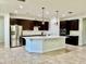 Modern kitchen featuring a large center island, stainless steel appliances, and dark cabinets at 2301 Avellino Ave, St Cloud, FL 34771