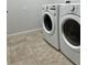 Tiled laundry room featuring a new white front-load washing machine and dryer at 2301 Avellino Ave, St Cloud, FL 34771