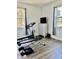 Bright workout room featuring a weight bench, treadmill, and laminate floors at 2301 Avellino Ave, St Cloud, FL 34771