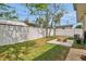 Lovely backyard with a white fence offering privacy, a firepit and a grassy yard at 2811 S Peninsula Dr, Daytona Beach, FL 32118