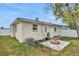 Cozy backyard featuring a brick fire pit area with green grass and a fenced yard at 2811 S Peninsula Dr, Daytona Beach, FL 32118