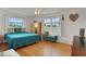 Bright bedroom with two windows, hardwood floors, and modern furnishings at 2811 S Peninsula Dr, Daytona Beach, FL 32118