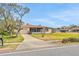 Charming home featuring a well-manicured lawn, inviting front porch, and attached garage at 2811 S Peninsula Dr, Daytona Beach, FL 32118