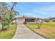 Inviting home with a well-kept lawn, attached garage, and charming front porch at 2811 S Peninsula Dr, Daytona Beach, FL 32118