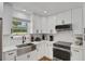 Modern kitchen with bright white cabinets, subway tile backsplash, and stainless steel appliances at 2811 S Peninsula Dr, Daytona Beach, FL 32118