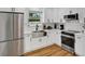Modern kitchen boasts stainless steel appliances, white cabinetry, and an undermount sink at 2811 S Peninsula Dr, Daytona Beach, FL 32118