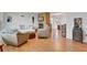 Spacious living room with hardwood floors, a brick fireplace, and comfortable seating arrangements at 2811 S Peninsula Dr, Daytona Beach, FL 32118