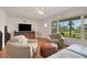 Cozy living room featuring ample seating, natural light, and hardwood flooring throughout the space at 2811 S Peninsula Dr, Daytona Beach, FL 32118