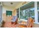 Relaxing screened porch featuring cozy seating, brick accents, and charming decor for outdoor enjoyment at 2811 S Peninsula Dr, Daytona Beach, FL 32118