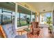 Inviting screened porch with comfortable seating, decorative tile flooring, and views of the neighborhood at 2811 S Peninsula Dr, Daytona Beach, FL 32118