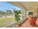 Comfortable screened porch offering a tranquil outdoor space with plants and a view of the surrounding landscape at 2811 S Peninsula Dr, Daytona Beach, FL 32118