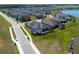See this home from above featuring a screened in lanai and solar panels on the roof at 2942 Wordsmith Rd, Kissimmee, FL 34746