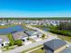 Aerial view of a lakeside community showcasing the neighborhood layout and landscaping at 2942 Wordsmith Rd, Kissimmee, FL 34746